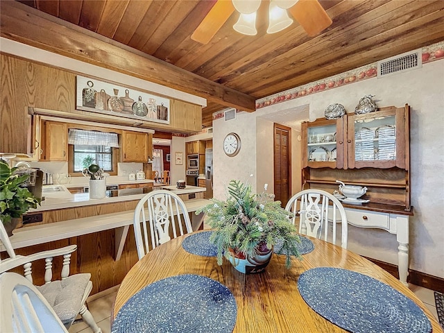 dining space featuring ceiling fan, wood ceiling, and beamed ceiling