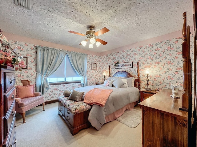 carpeted bedroom with a textured ceiling and ceiling fan