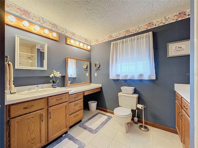 bathroom with toilet, tile patterned flooring, walk in shower, a textured ceiling, and vanity