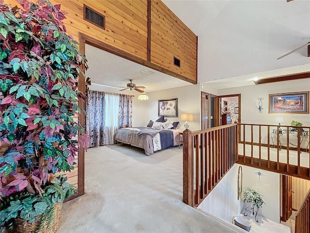 carpeted bedroom featuring lofted ceiling, ceiling fan, and a textured ceiling