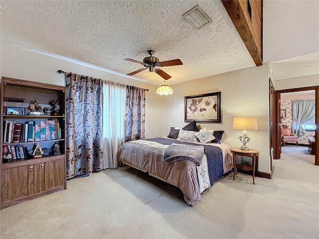 carpeted bedroom featuring ceiling fan, beamed ceiling, and a textured ceiling