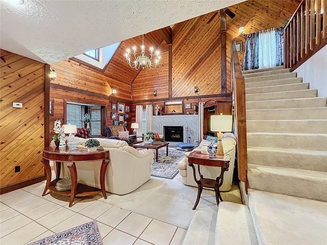 tiled living room featuring a brick fireplace, wood walls, and high vaulted ceiling