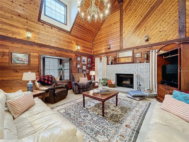 living room featuring high vaulted ceiling, an inviting chandelier, wood walls, and a fireplace