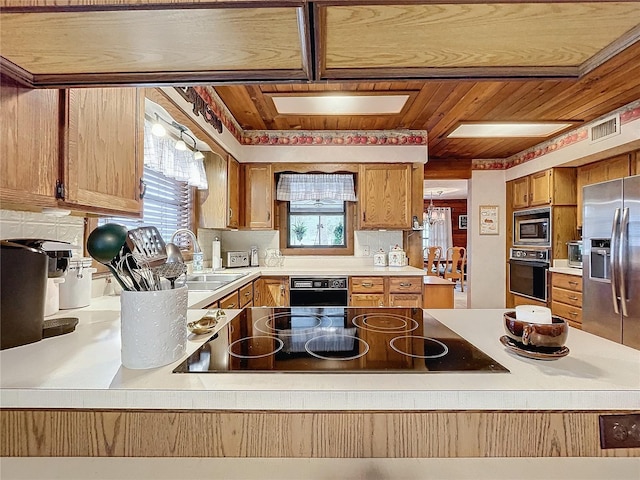 kitchen featuring black appliances, sink, and wooden ceiling