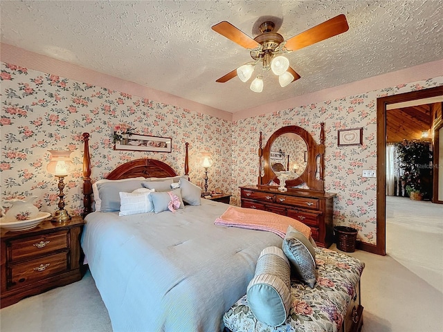 carpeted bedroom with ceiling fan and a textured ceiling