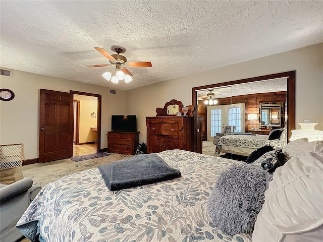 bedroom featuring a textured ceiling, ceiling fan, and french doors