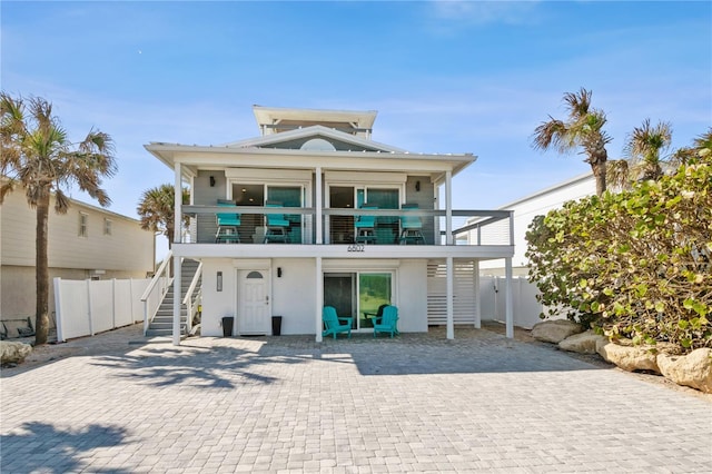 view of front of house featuring a balcony