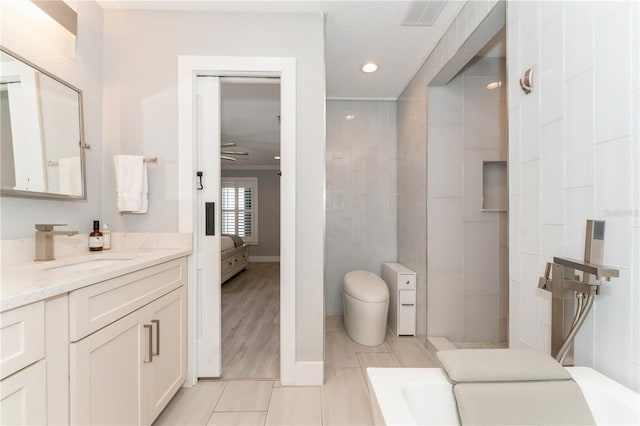 bathroom with tile patterned floors, vanity, toilet, ceiling fan, and crown molding