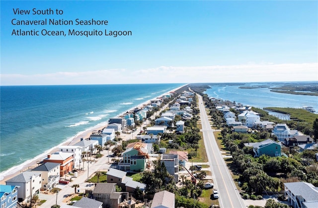 birds eye view of property with a view of the beach and a water view