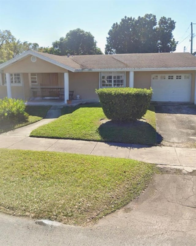 single story home featuring a front lawn and a garage