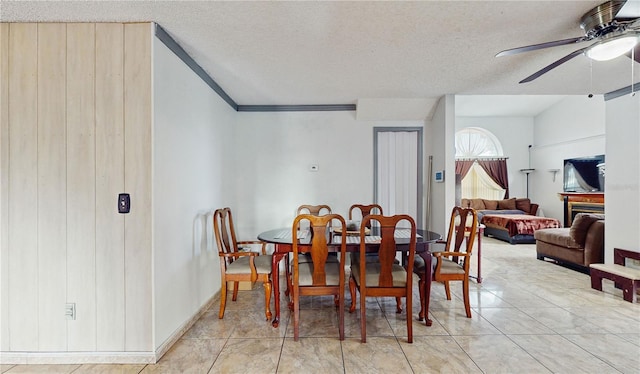 dining room featuring ceiling fan, vaulted ceiling, and a textured ceiling