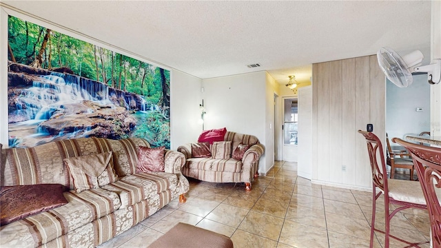 living room featuring a textured ceiling and light tile patterned floors