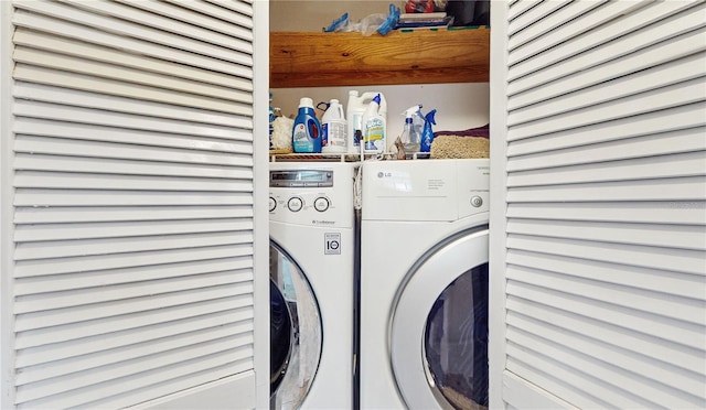 clothes washing area with separate washer and dryer