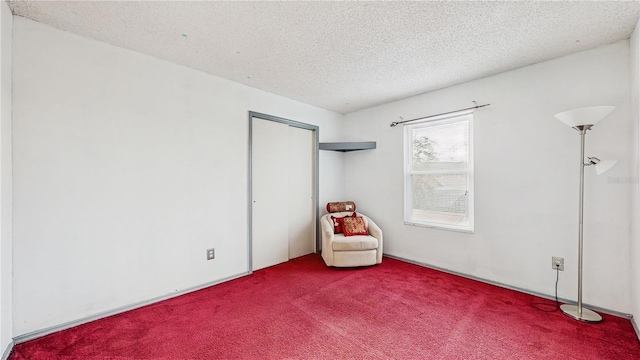 unfurnished room featuring a textured ceiling and carpet floors