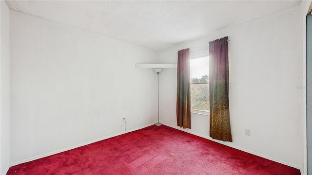 carpeted spare room featuring a textured ceiling