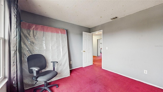 home office featuring a textured ceiling and carpet flooring