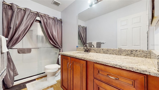 bathroom with toilet, vanity, a shower with curtain, and hardwood / wood-style floors