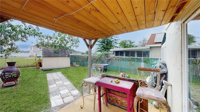 view of patio with a storage unit