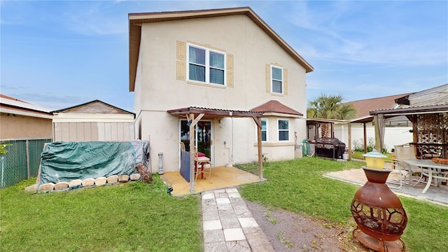 rear view of property with a pergola, a yard, and a patio