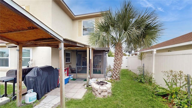 rear view of house with a sunroom and a yard