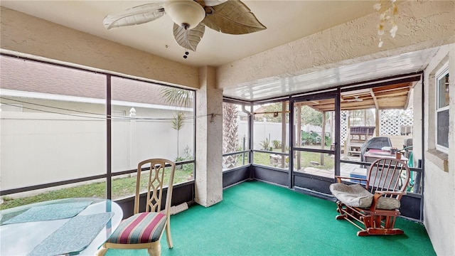 sunroom featuring ceiling fan