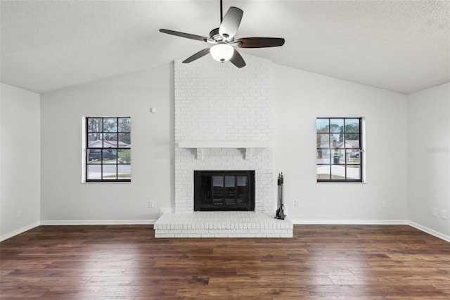 unfurnished living room with dark hardwood / wood-style floors, a fireplace, and plenty of natural light