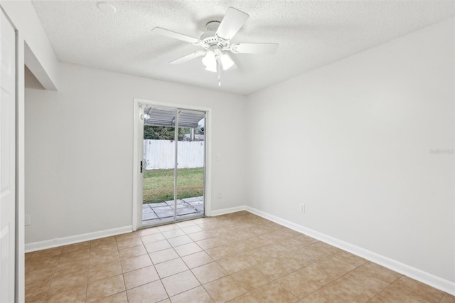 tiled spare room with a textured ceiling and ceiling fan