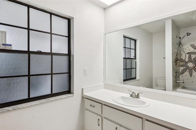 full bathroom featuring toilet, vanity, and bathing tub / shower combination