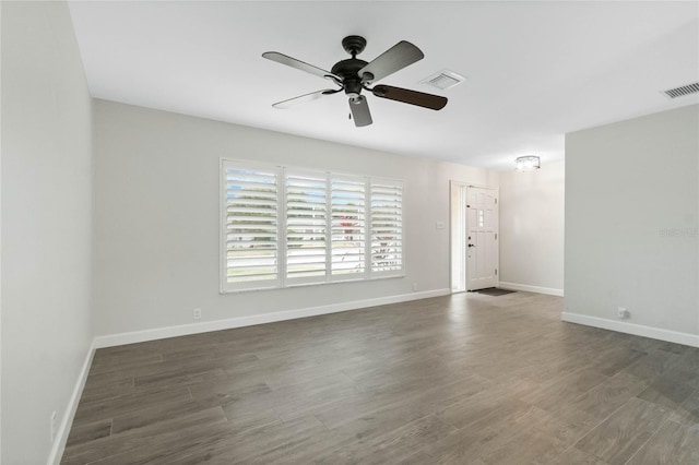 unfurnished room featuring dark wood-type flooring and ceiling fan