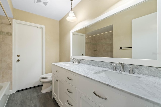 bathroom featuring wood-type flooring, toilet, and vanity