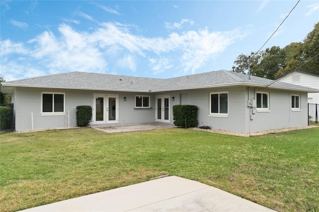 back of house featuring a patio area, french doors, and a yard