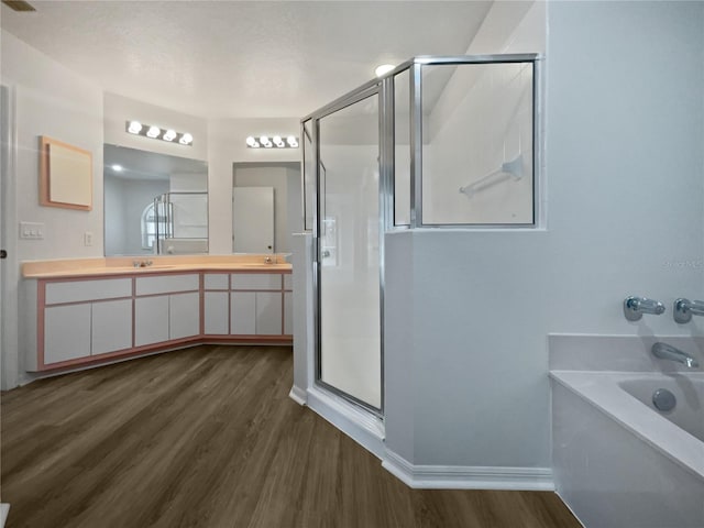 bathroom with vanity, shower with separate bathtub, and hardwood / wood-style flooring