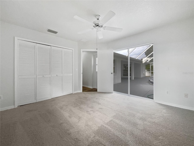 unfurnished bedroom with ceiling fan and carpet