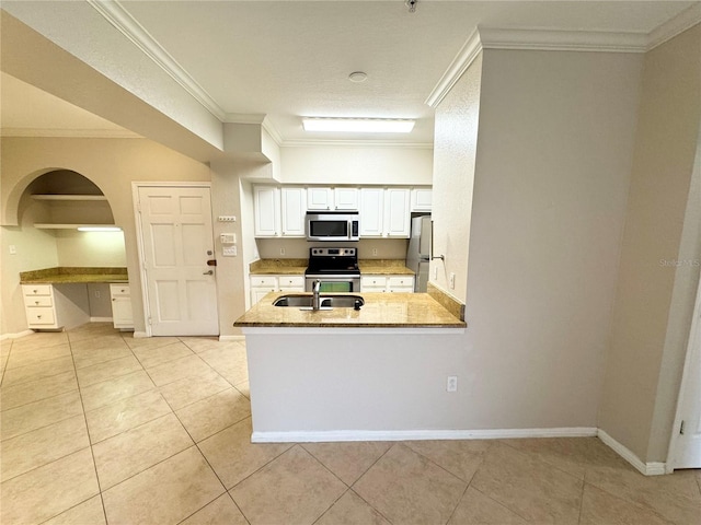 kitchen featuring light tile patterned floors, appliances with stainless steel finishes, ornamental molding, a peninsula, and a sink