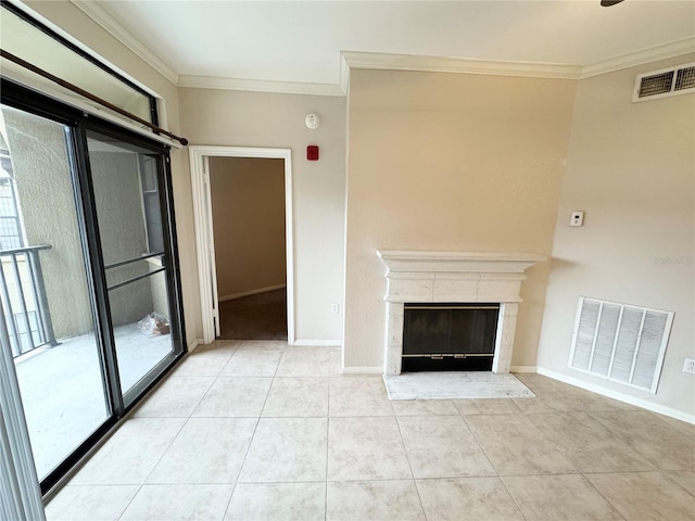 unfurnished living room with tile patterned floors, visible vents, crown molding, and a high end fireplace