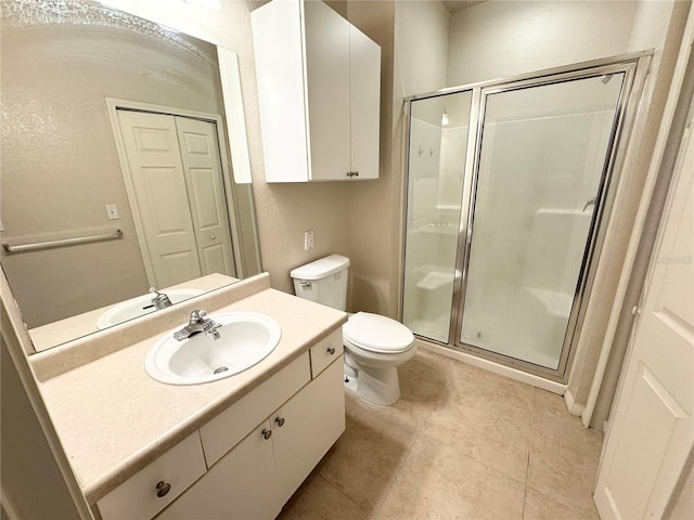 bathroom with a stall shower, tile patterned flooring, vanity, and toilet