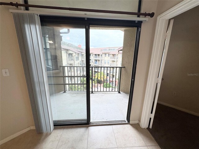 entryway featuring light tile patterned flooring and baseboards