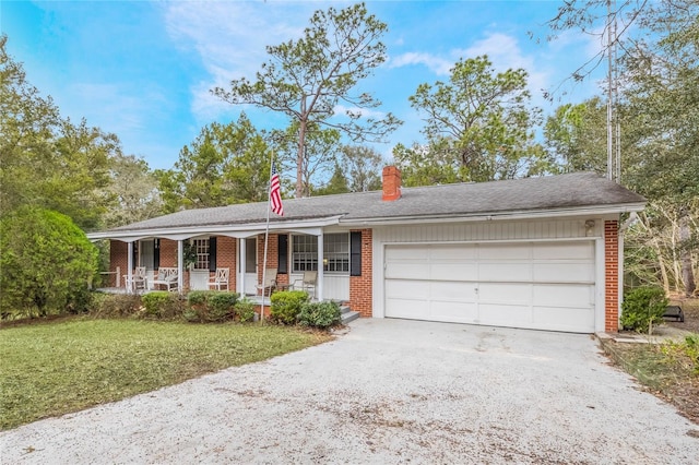 ranch-style home featuring a porch, a front yard, and a garage