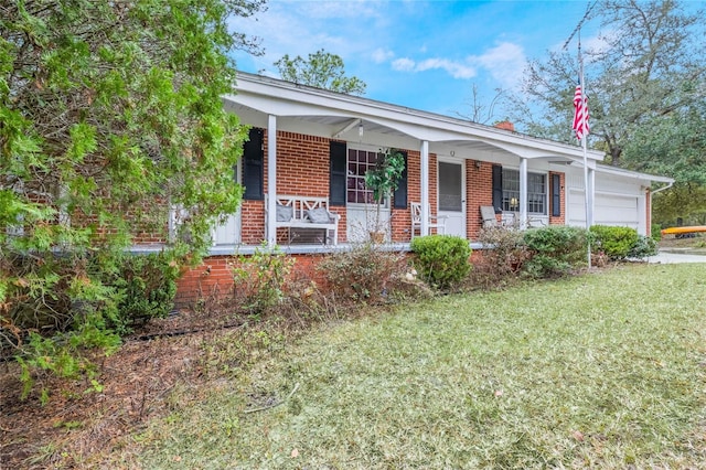 ranch-style home with a porch, a front yard, and a garage