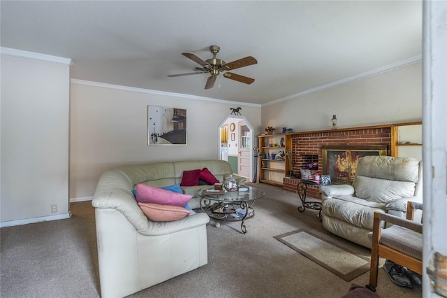 carpeted living room featuring a brick fireplace, ceiling fan, and crown molding