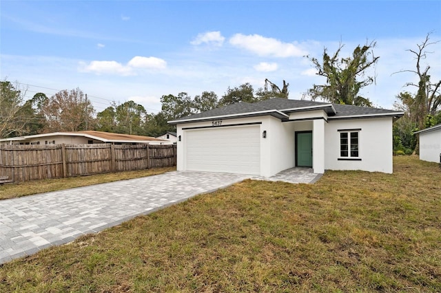 view of front of property with a front yard and a garage