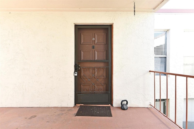 entrance to property with a balcony