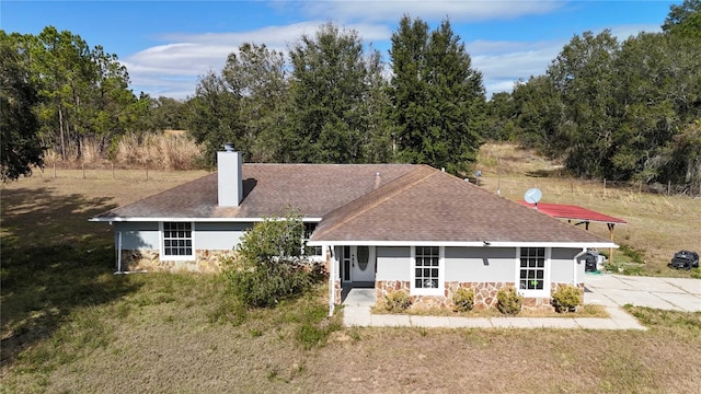 rear view of property with a lawn