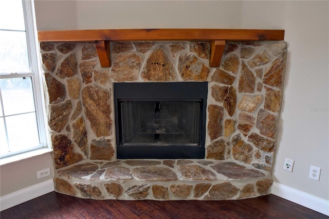 room details featuring hardwood / wood-style flooring and a stone fireplace