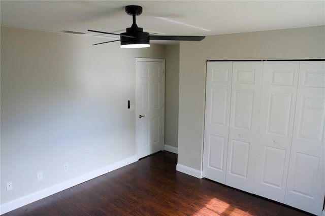 unfurnished bedroom featuring ceiling fan, a closet, and dark hardwood / wood-style floors