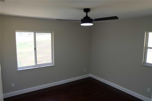 spare room featuring ceiling fan and dark hardwood / wood-style floors