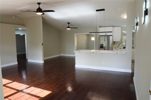 interior space featuring lofted ceiling, ceiling fan, and dark wood-type flooring