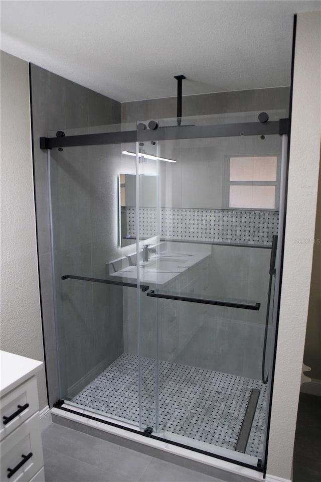 bathroom featuring an enclosed shower and vanity