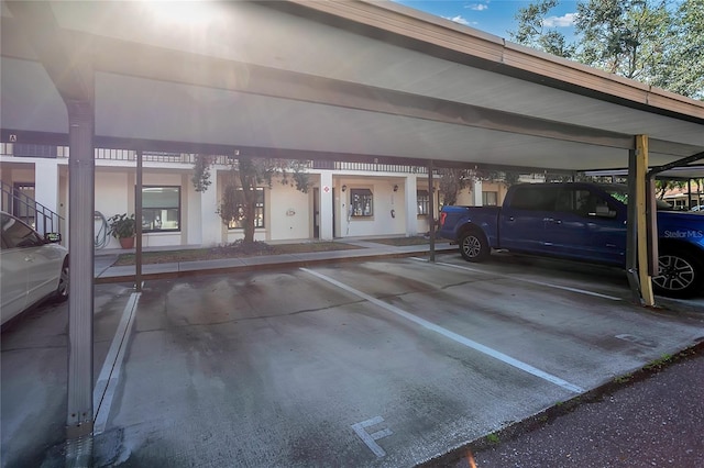 view of parking / parking lot featuring a carport