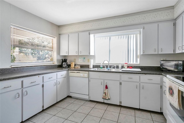 kitchen featuring white appliances, white cabinets, sink, and light tile patterned floors